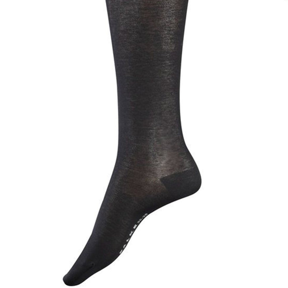 En fod i Falke 045680 Cotton Touch Black F knæstrømper, halvgennemsigtige, vist på en ensfarvet hvid baggrund.