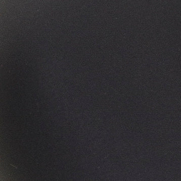 Et nærbillede af en mørk, ensartet overflade i trækulfarve, der minder om teksturen i stoffet »Marie Jo Tom Charcoal Mørkegrå«.